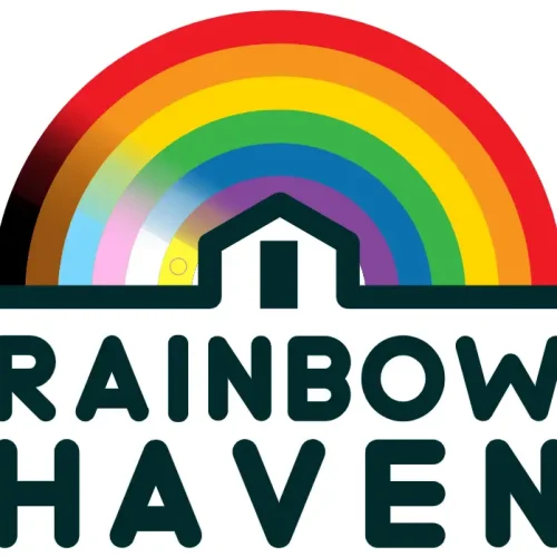 The diverse rainbow flag shelters a home, the place where our LGTBQAI+ brothers and sisters find safety on their journey